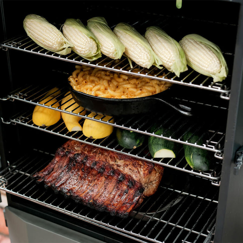 A black Masterbuilt Digital Charcoal Smoker with a glass window door, digital control panel, and wheels for mobility.