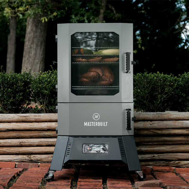 A black Masterbuilt Digital Charcoal Smoker with a glass window door, digital control panel, and wheels for mobility.